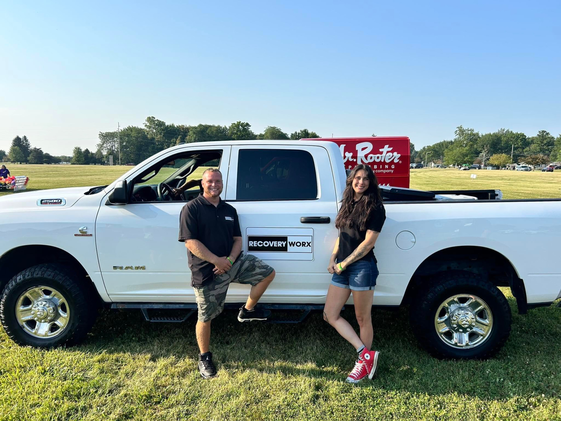 Recovery Worx team members standing beside the Recovery Worx truck at a community event